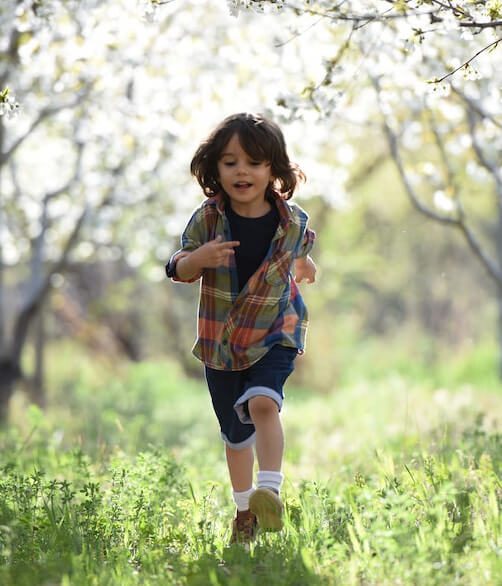 Enfant court dans un jardin